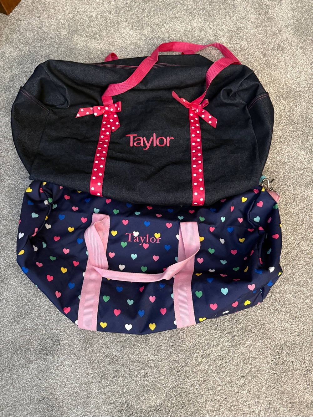 Two personalized duffle bags with TAYLOR name on them
